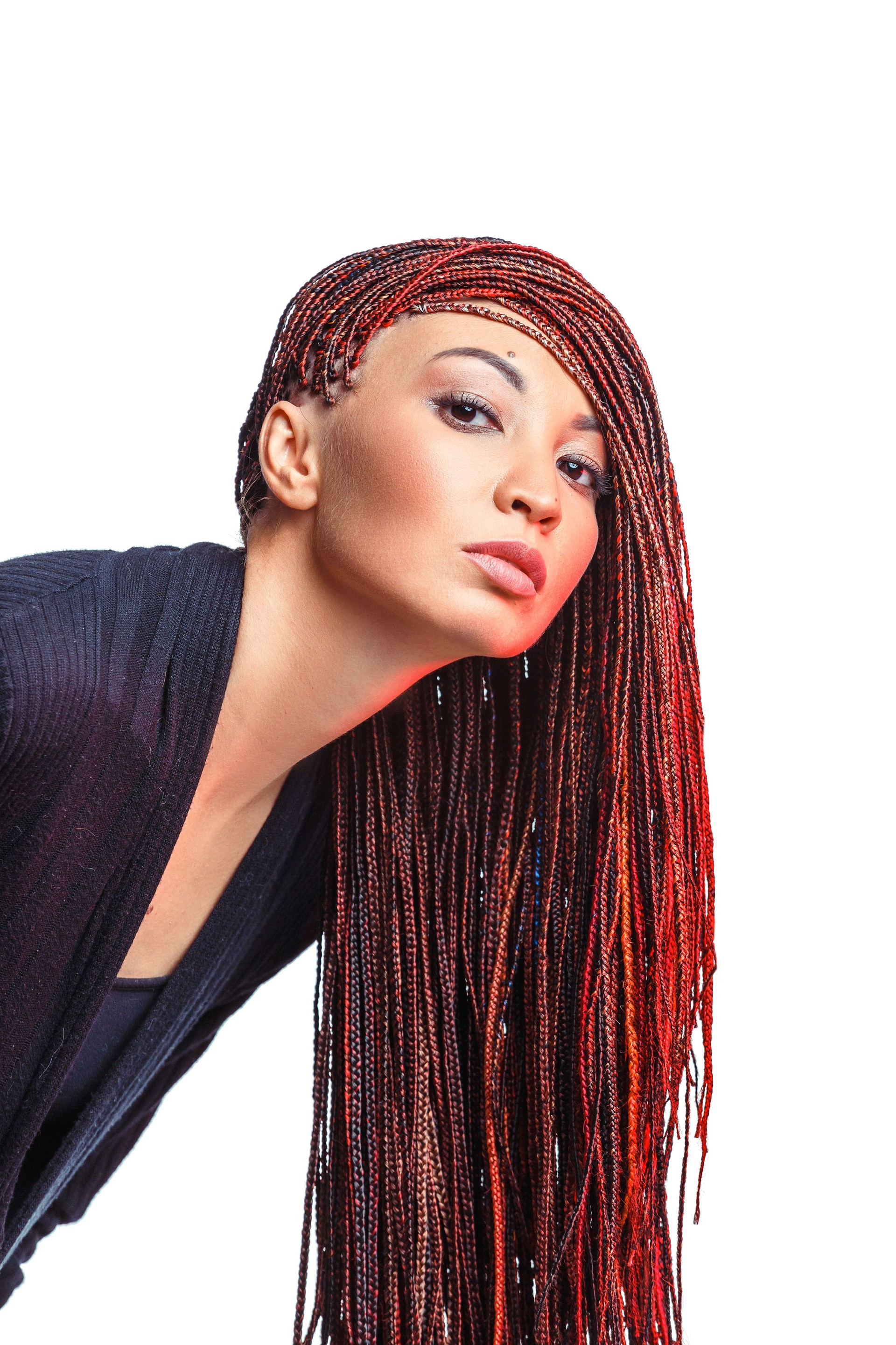 Isolated on white woman with colorful hair braided in thin plaits or dreadlocks in african style